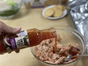 In a small mixing bowl, toss the shredded chicken with the Sweet Chili Sauce.