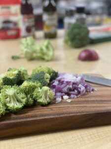 Chop the broccoli and red onion. 